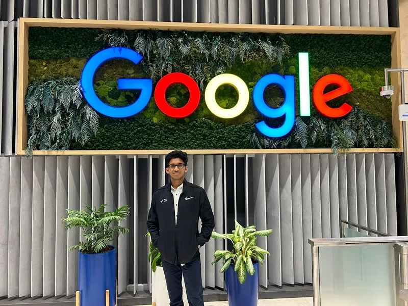 Mishal Abdullah standing beneath the Google logo